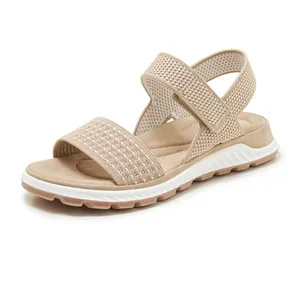 Close-up of beige fly-knit sports sandals with soft TPR sole for women's casual wear
