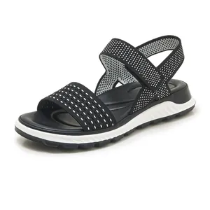 Detailed side view of breathable black and white knitted women's sports sandal with wedge sole