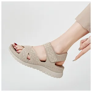 Close-up of beige breathable mesh sport sandals with thick non-slip soles and velcro straps