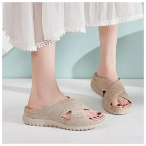 Close-up detail of beige fly-knit cross-strap platform sandals with thick hollow soles