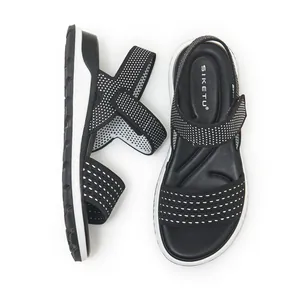 Close-up detail of women's knit sports sandals featuring black and white dotted pattern