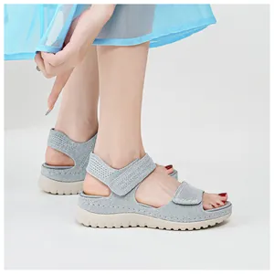 Close-up view of grey mesh sports sandals with velcro straps and platform sole