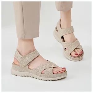 Close-up of beige women's sporty platform sandals with hollow-out design and velcro straps