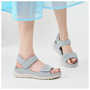 Detailed view of grey mesh sports sandals with velcro straps and thick soles