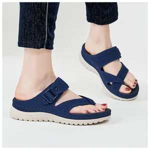 Navy blue mesh sports sandals with thick white soles and adjustable buckle detail