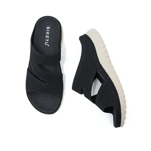 Detailed view of black woven women's sporty slides with thick beige platform sole
