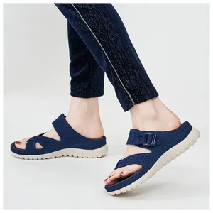 Detailed side view of navy blue mesh sports sandals with thick white soles on feet