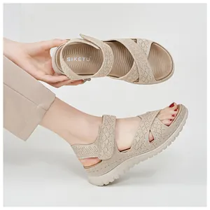 Detail of beige platform sports sandals with velcro straps and hollow-out design