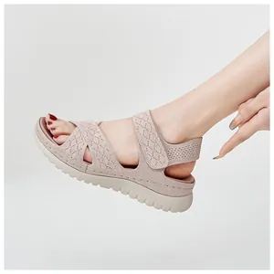 Side view of women's pink knit sports sandals with velcro strap and platform sole