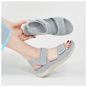 Light gray mesh women's sports sandals with adjustable velcro straps on white background