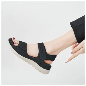 Detail view of women's black sports sandals with velcro strap and thick sole