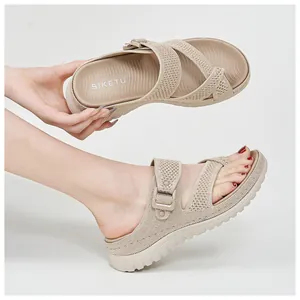Detail view of beige platform sports sandals with adjustable velcro straps and mesh upper