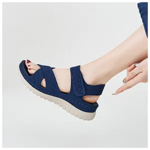 Side view showing the fit and adjustable velcro strap of the navy blue platform sandal