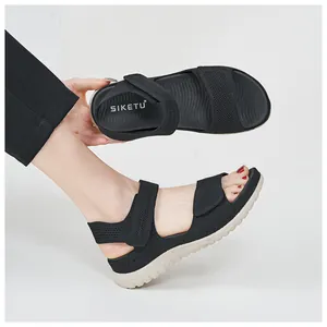 Side and insole view of black women's sports sandals with breathable mesh and hook and loop