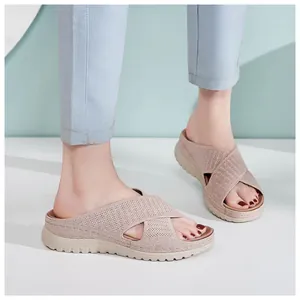 Close-up of model wearing breathable knitted cross strap platform sandals in casual beige