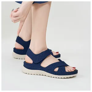 Close-up detail of navy blue mesh platform sandals with velcro strap and hollow-out design
