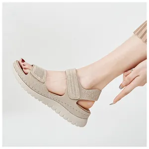 Detailed view of beige mesh platform sandals with adjustable velcro straps on model
