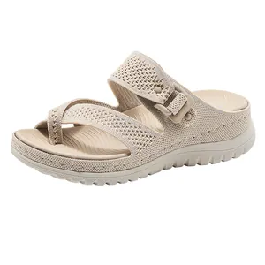 Side view of beige wedge sandals featuring breathable mesh knit and buckle strap