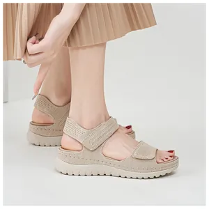 Detailed view of beige breathable mesh wedge sandals with adjustable Velcro straps