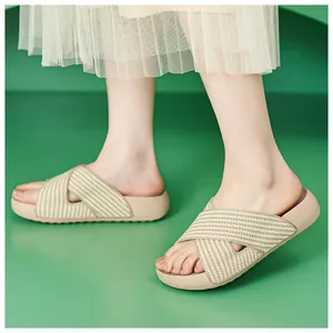 Close-up of beige platform sandals with criss-cross woven fabric straps