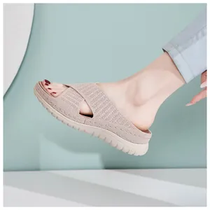 Detailed view of beige mesh knit platform slide sandals with thick serrated sole.