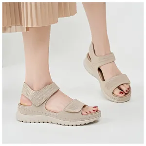 Close-up of beige women's sport sandals with adjustable velcro straps and thick platform soles
