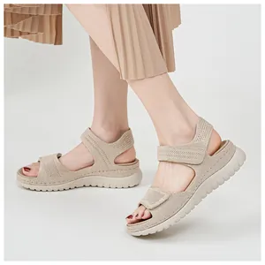Detailed view of women's beige sporty sandals with velcro straps and hollow mesh