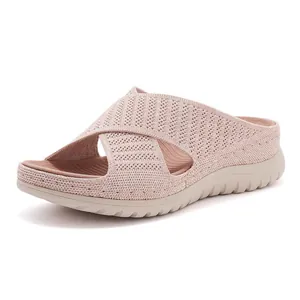 Detailed side view of breathable pink knit sports slide sandals featuring a thick comfort sole.