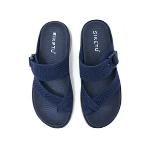 Top view detail of navy blue woven sandals with adjustable buckle and textured sole