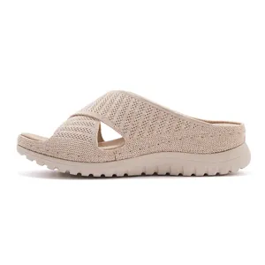 Side profile view of beige knitted wedge slide sandals for women with textured sole