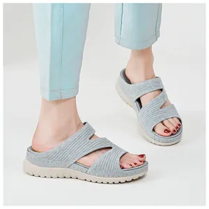 Detail of the breathable knitted hollow straps on these gray sporty platform sandals