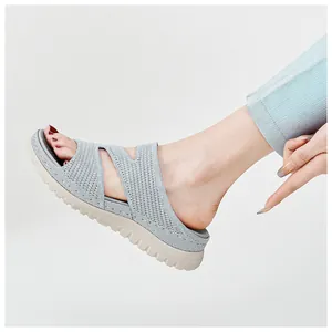 Close-up of women's grey knitted sports sandals with thick jagged soles