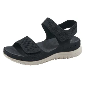 Close-up of black sports sandals with breathable mesh straps and thick beige sole