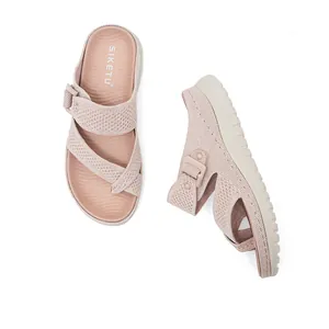 Close-up of pink mesh women's sandals with adjustable velcro strap and thick sole