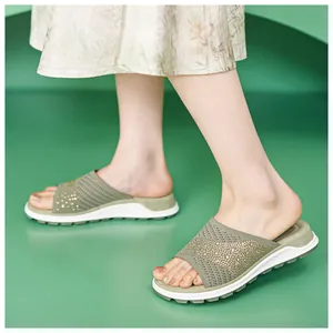 Detailed view of women's sage green knit flat sandals with rhinestone mesh upper