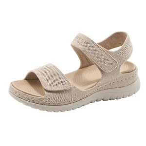 Detailed macro view of beige knit platform wedge sandals with adjustable velcro straps.