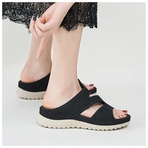 Detail shot of women's black platform wedge slides with breathable mesh straps