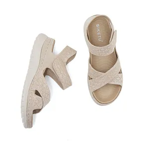 Detailed view of women's beige knit sporty sandals with platform sole and Velcro strap