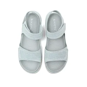 Top view of light blue sporty sandals with knitted hollow upper and Velcro strap