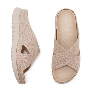 Detailed macro view of beige fly-knit woven straps on women's thick platform sandals