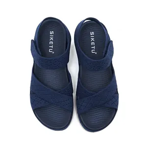 Top view detail of navy blue sports sandals with cross straps and velcro closure.