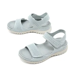 Side view of women's grey knit sandals with velcro straps and comfortable thick soles