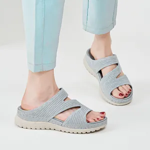 Comfortable light blue women's sporty slides with thick beige soles and hollow-out design.