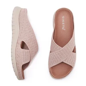 Detailed view of pink knitted platform slide sandals with breathable cross straps