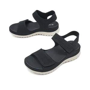 Detailed view of black women's mesh sports sandals with chunky soles and velcro.