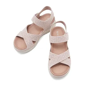 Detailed view of pink sporty sandals featuring woven mesh straps and platform sole