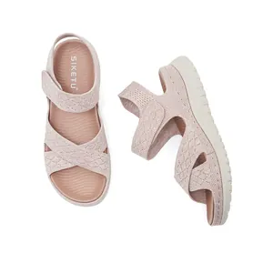 Pink hollow knit sports sandals with thick platform sole and velcro strap closure.