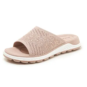 Close-up of women's rhinestone fly-knit slide sandal with comfortable cushioned sole