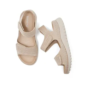 Women's beige sports sandals featuring breathable knit texture and adjustable Velcro straps