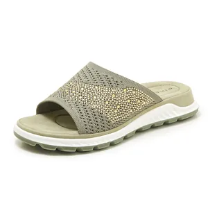 Detailed view of women's olive green fly-woven slide sandal with sparkling rhinestone accents